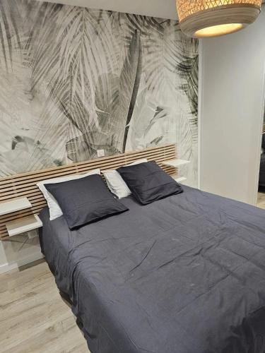 a bed with two pillows on it in a bedroom at Villa de 4 chambres avec piscine privee sauna et jardin clos a Riom in Riom