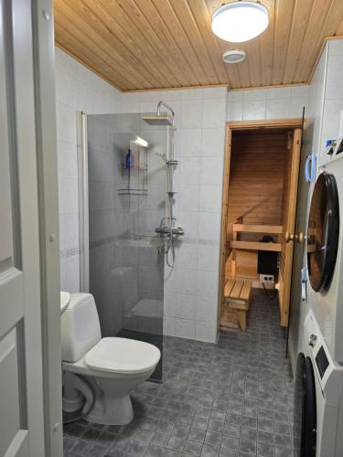 a bathroom with a toilet and a walk in shower at Moderni kaksio Kuopion keskustassa in Kuopio