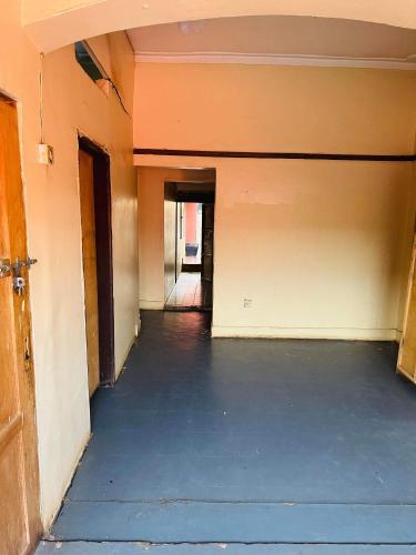 an empty hallway of a building with a garage at Zion guest house Kampala Uganda in Kampala