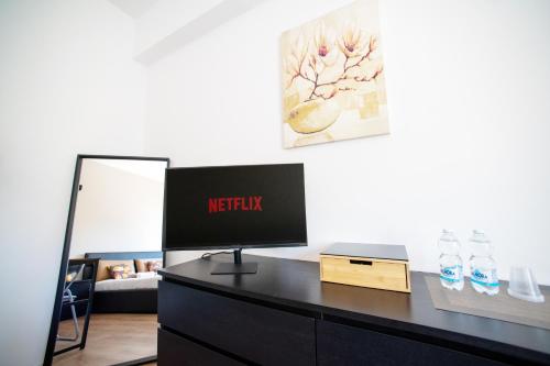 a desk with a monitor on it in a room at Savona Sea House Apartment in Savona