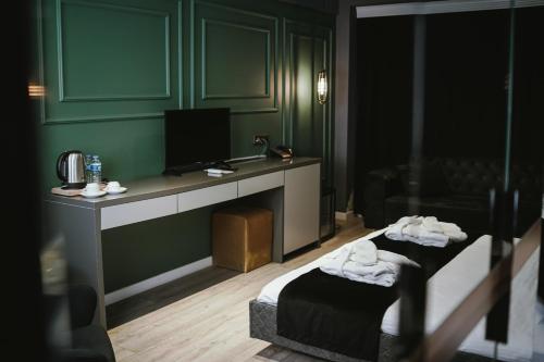 a hotel room with two beds and a television at ENNA SUIT HOTEL in Nilüfer