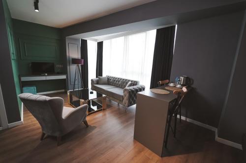 a living room with a couch and a chair at ENNA SUIT HOTEL in Nilüfer