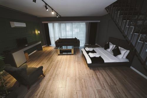 a living room with a bed and a staircase at ENNA SUIT HOTEL in Nilüfer