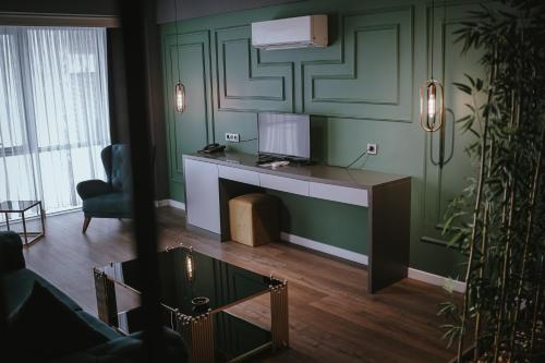 a living room with a desk with a computer on it at ENNA SUIT HOTEL in Nilüfer