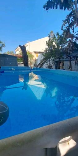 - une piscine d'eau bleue en face d'un bâtiment dans l'établissement Beach House, à Ashdod
