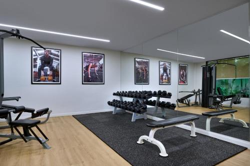 a gym with treadmills and exercise equipment in a room at Plantation Urban Resort & Spa in Phnom Penh