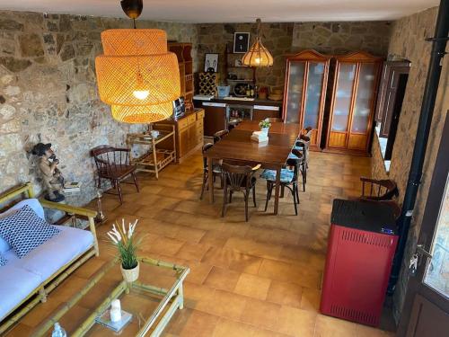 a living room with a table and chairs and a couch at La Costana - San Cucao de Llanera in Agüera