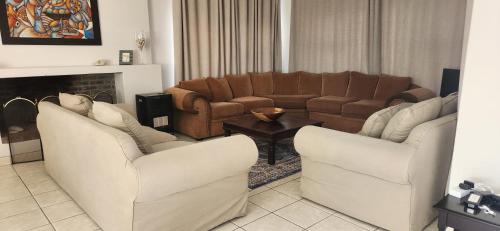 a living room with two chairs and a couch at Picollo Bocca Villa Kleinmond in Kleinmond