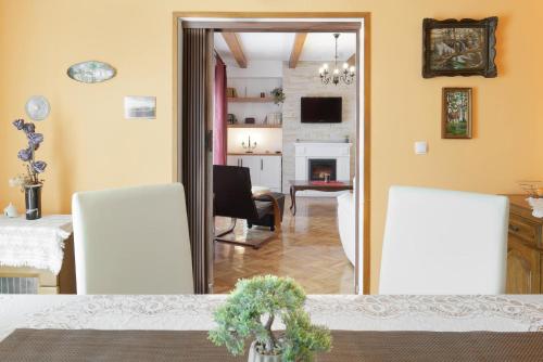 a dining room with a table and a living room at Holiday Home Vlady in Buje