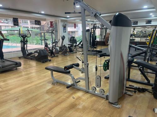 a gym with a bunch of treadmills and machines at Luxury 3 bedroom independent appartment in Ghaziabad