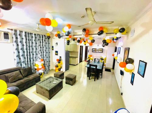 a living room with a couch and a table with balloons at Luxury 3 bedroom independent appartment in Ghaziabad