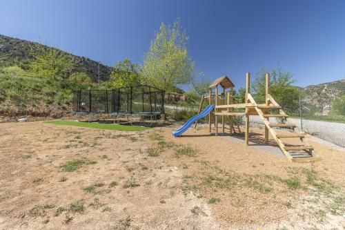 a playground with a slide and a swing set at Móvil Home Grande in Alós de Balaguer