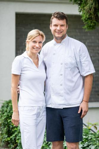 a man and a woman posing for a picture at Hotel Radun in Luhačovice