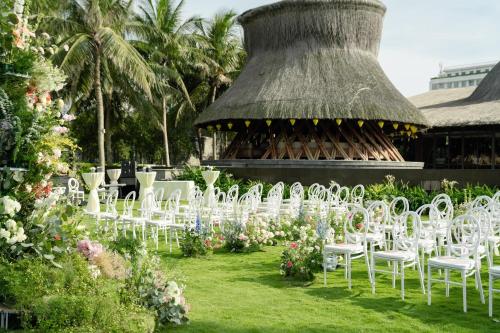 a row of white chairs in front of a building at Naman Retreat in Da Nang