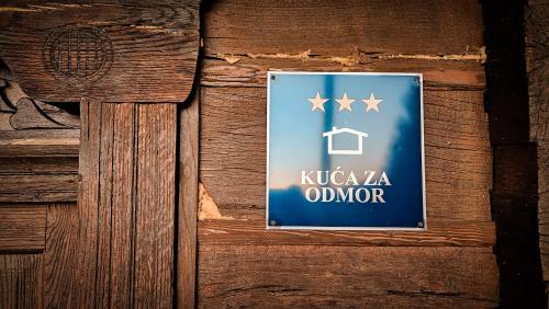 a sign on a wooden door with a house and stars at Country home Lagom in Zagorska Sela