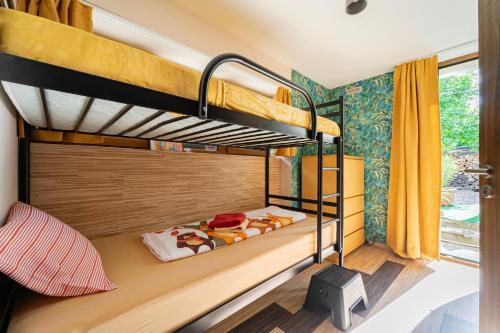 a bunk bed in a room with two bunk beds at B48 Simplex - egyszinten, kényelmesen in Törökbálint