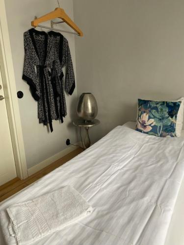 a bedroom with a bed with white sheets at Brohuspark in Lomma