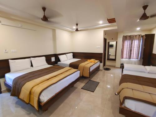 a hotel room with two beds in it at HOTEL DKR GRAND in Tirupati