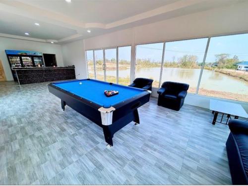 a living room with a pool table and chairs at Chaiyaphum Monster Fishing Resort in Ban Huai Kum