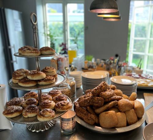 a table topped with three tiers of donuts and pastries at Brohuspark in Lomma