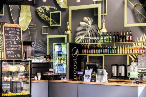 a coffee shop with a counter with drinks on it at Hotel Bastion in Malbork