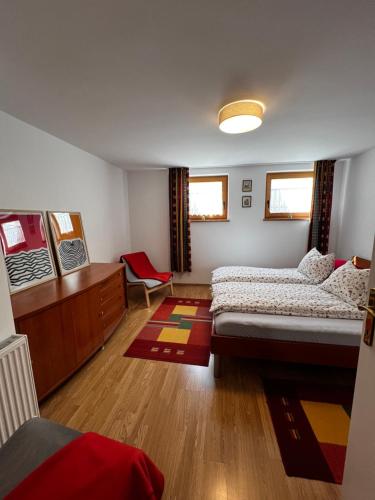 a bedroom with two beds and a chair in it at Morning coffee w a view :) in Podčetrtek