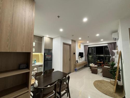 a kitchen and living room with a table and chairs at Gao Homestay - Venuestay in Hue