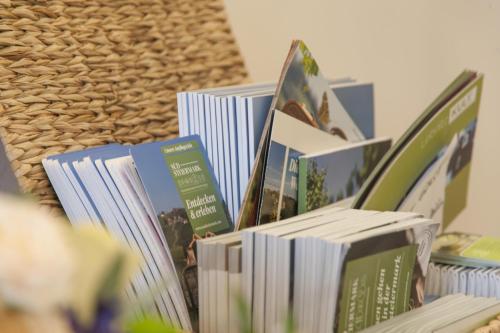 a pile of books sitting on top of a shelf at Ferienwohnung Foller in Leutschach