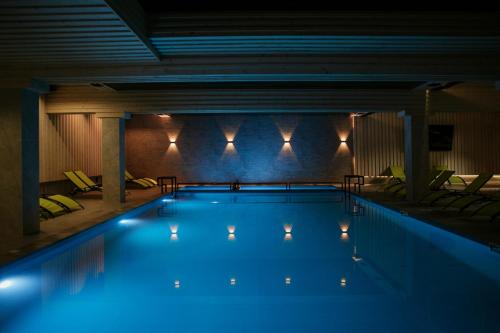 a large swimming pool with lights in a building at Гетьман Готель & SPA in Chortkiv