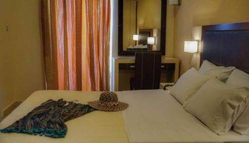 a hotel room with a hat on a bed at GOLDEN SUN Κokkoni Beach Hotel in Vrahati