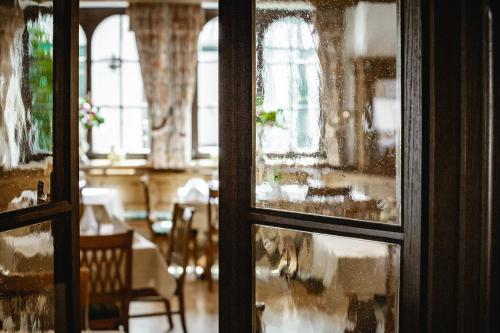a view of a dining room through a window at Hotel Post Abtenau in Abtenau