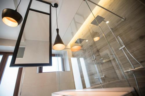 a bathroom with a shower and a glass shower stall at Albergo Diffuso Dimora Rossi Suite B&B in Turi