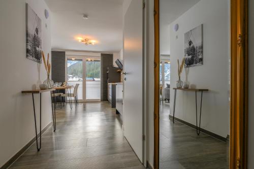 a hallway with a dining room and a living room at Ferienwohnung Klugis in Gosau