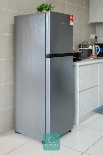 a stainless steel refrigerator in a kitchen at JOMSTAY Sunway Onsen Suites Ipoh - Lost World of Tambun Ipoh Waterpark in Tambun