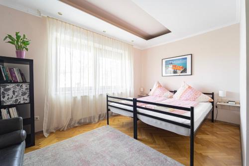 a bedroom with a bed and a large window at B48 Bigflat in Törökbálint