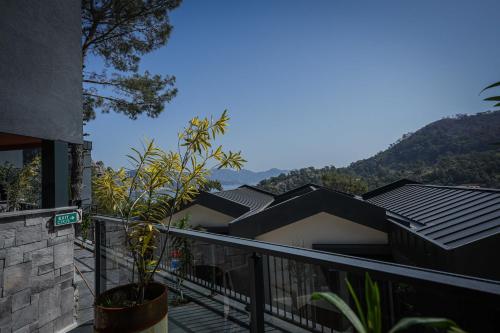 a balcony of a house with mountains in the background at Ramitos Hotel in Turunc