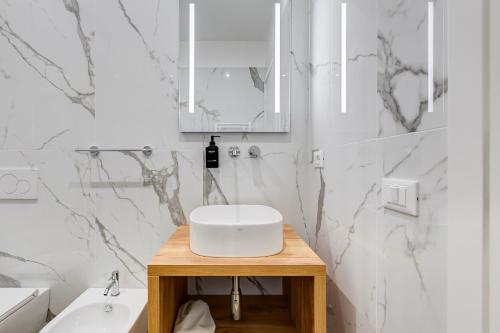 a white bathroom with a sink and a mirror at LISA SUITE in Rome