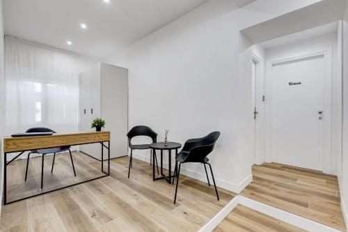 a room with chairs and a table and a door at LISA SUITE in Rome