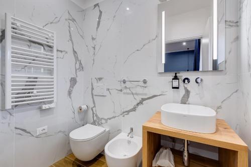 a white bathroom with a sink and a toilet at LISA SUITE in Rome