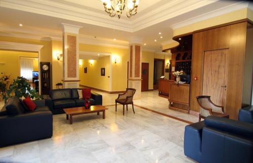 a living room with a couch and chairs and a table at Hotel Reale in Fiuggi
