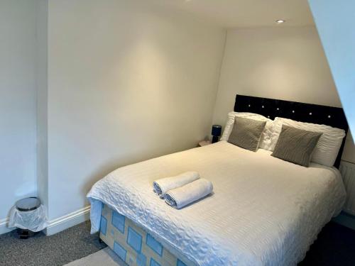 a bedroom with a bed with two towels on it at Comfortable City Centre Room in Bristol