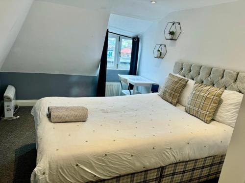 a bedroom with a large bed and a desk at Lovely City Centre Room in Bristol