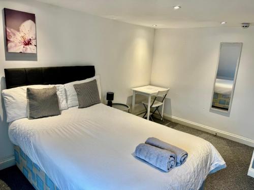 a bedroom with a large bed with two towels on it at Large City Centre Room in Bristol