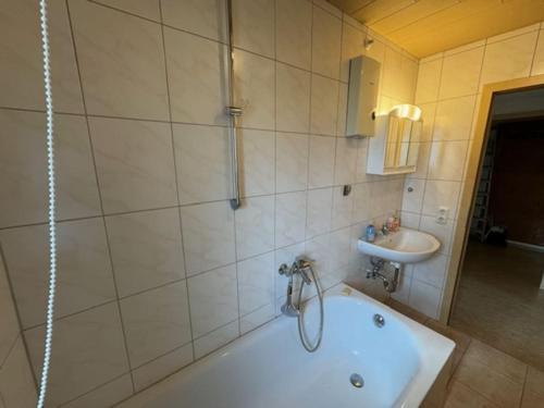 a bathroom with a tub and a sink at Schöne Wohnung mit Erker 