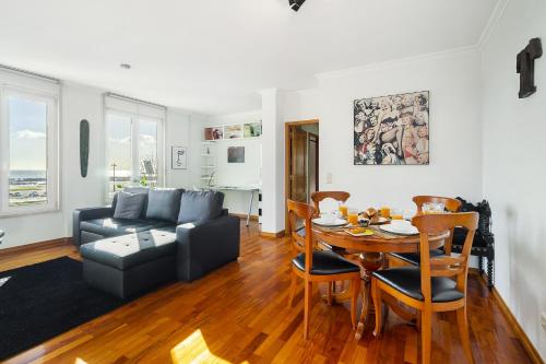 a living room with a table and a couch at Lisbon Riverview Apartment by Premium Lisbon Stays in Lisbon