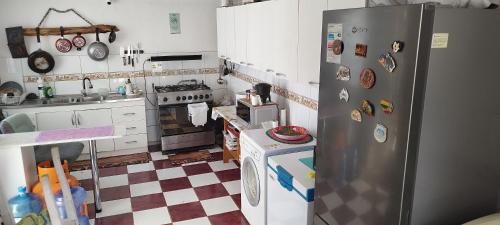 a kitchen with a refrigerator and a checkered floor at Shalom_MatSofy in Santiago