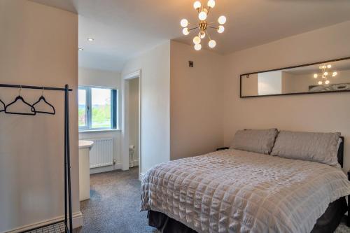 a bedroom with a bed and a mirror on the wall at Finest Retreats - Stone Bow Farmhouse in Weston-super-Mare