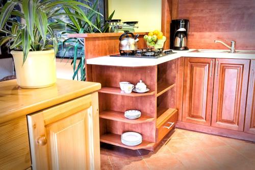 a kitchen with a counter and a sink and a kitchen with a sink at Pension Aqualand in Poprad