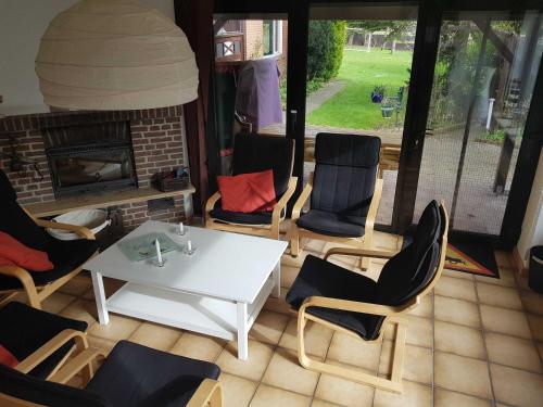 a patio with a table and chairs and a fireplace at Ferienhaus Seestern in Schwackendorf