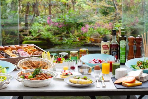 a table filled with plates of food and drinks at The Westin Osaka in Osaka